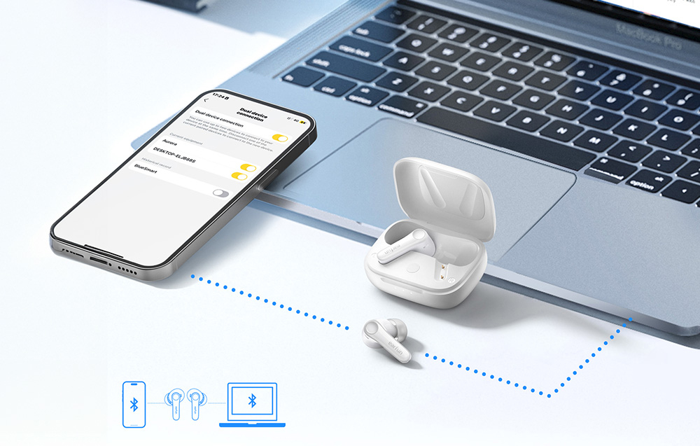 Smartphone και φορητός υπολογιστής συνδεδεμένα μέσω Bluetooth με ασύρματα ακουστικά και θήκη που βρίσκονται δίπλα τους